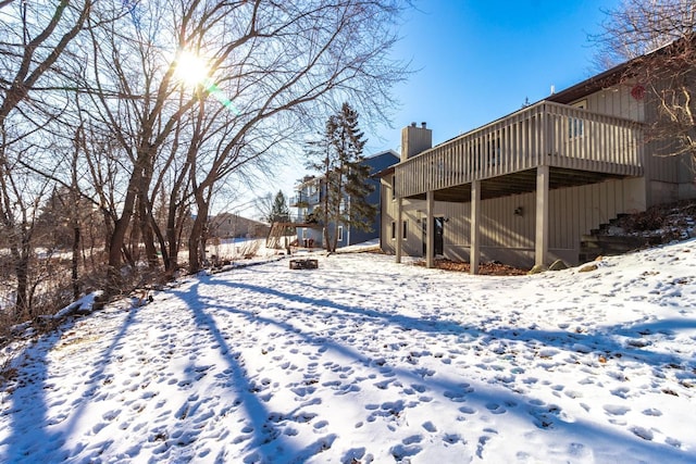 yard covered in snow featuring a wooden deck