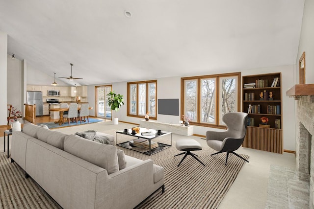 carpeted living room with a brick fireplace and lofted ceiling