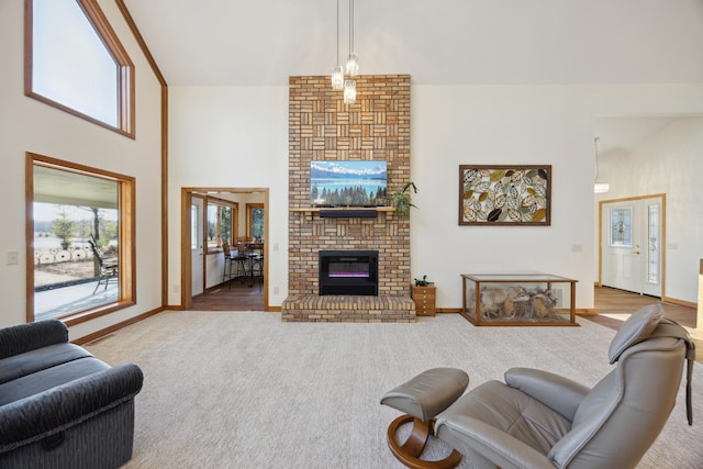 carpeted living room with a brick fireplace and a towering ceiling