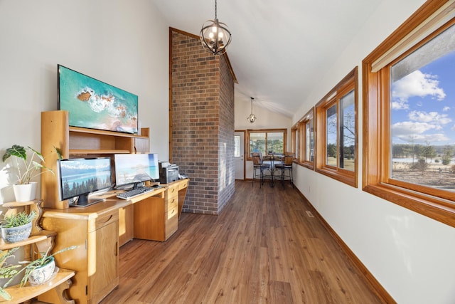 interior space featuring an inviting chandelier, dark wood-type flooring, and high vaulted ceiling