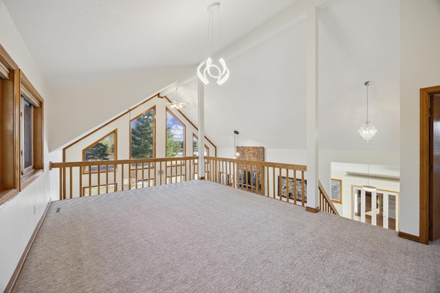 additional living space featuring beam ceiling, high vaulted ceiling, a chandelier, and carpet