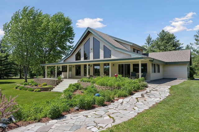 back of property with a yard and a porch