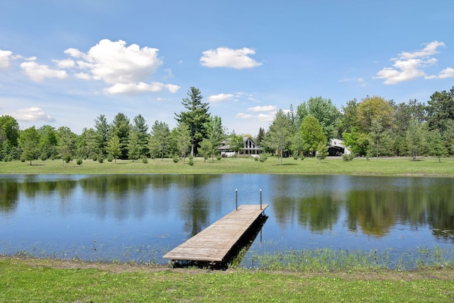 dock area with a lawn and a water view