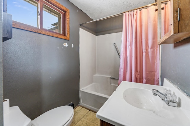 full bathroom with vanity, shower / tub combo, toilet, tile patterned floors, and a textured ceiling