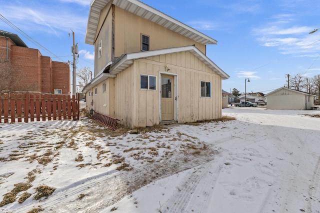 view of snow covered rear of property