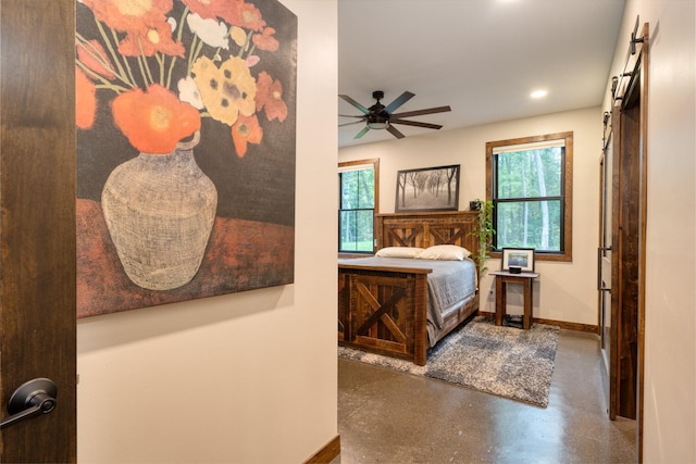 bedroom with concrete floors, multiple windows, and ceiling fan