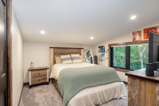 bedroom featuring light carpet and lofted ceiling