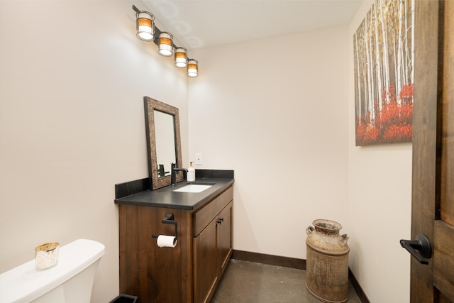 bathroom featuring toilet and vanity