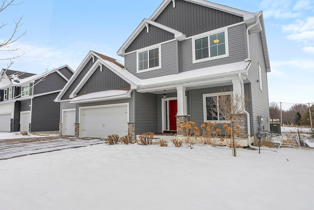 craftsman inspired home with covered porch, board and batten siding, and a garage