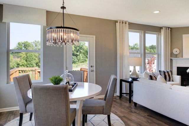 dining area with dark hardwood / wood-style flooring and a notable chandelier