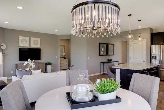 dining area featuring a chandelier and wood-type flooring