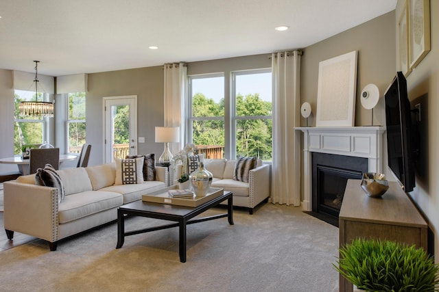 living room featuring light carpet and a chandelier