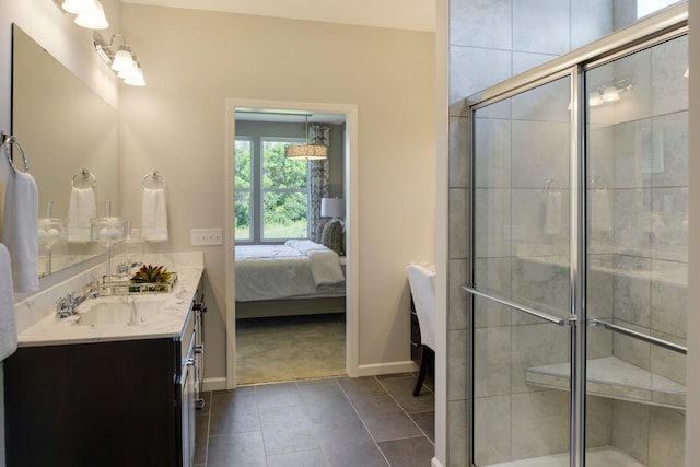 bathroom with tile patterned floors, a shower with door, and vanity