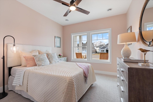 bedroom with ceiling fan and light carpet