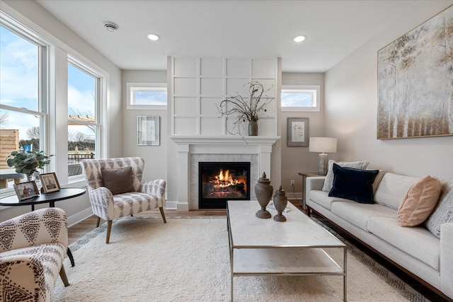 living room featuring hardwood / wood-style flooring and a tile fireplace