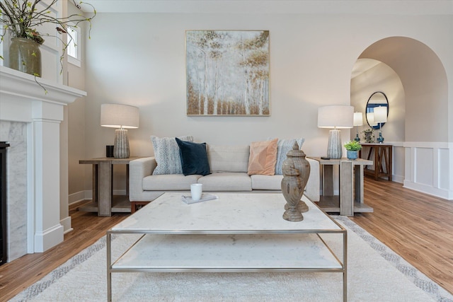 living room with a fireplace and light hardwood / wood-style flooring