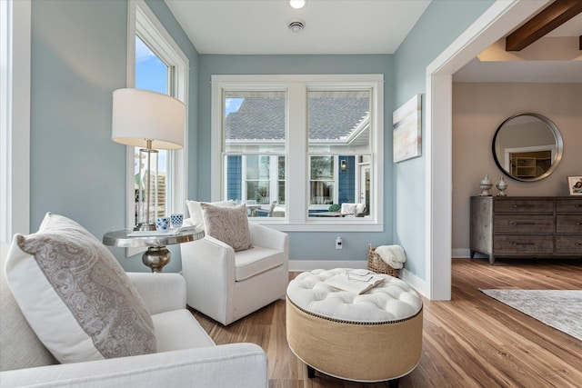 sitting room with hardwood / wood-style flooring and plenty of natural light