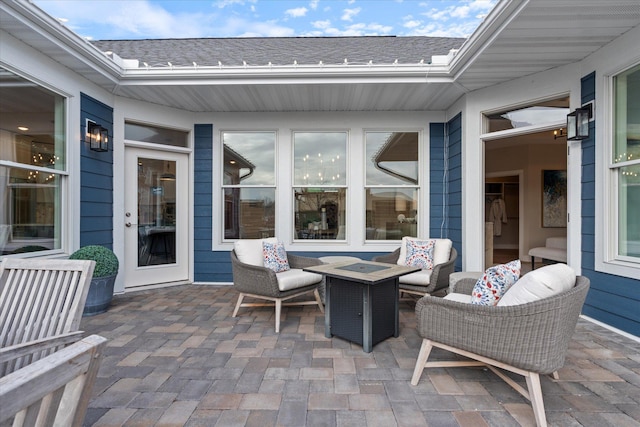 view of patio / terrace with an outdoor living space with a fire pit