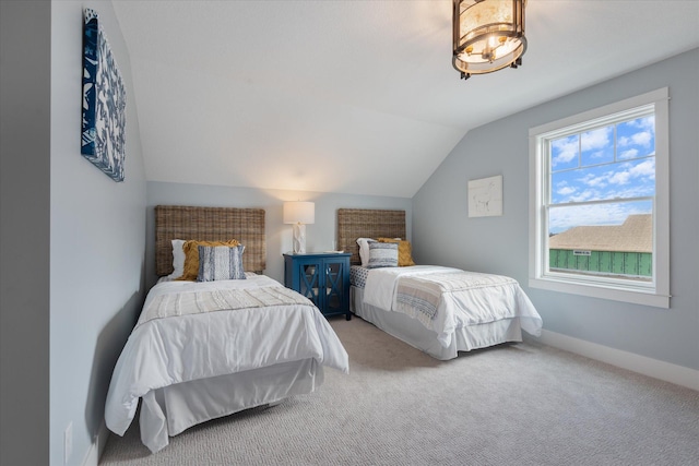 carpeted bedroom with vaulted ceiling