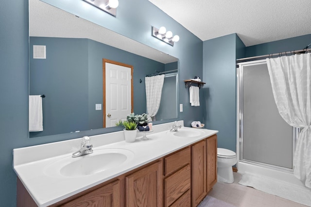 bathroom with a shower with curtain, toilet, a textured ceiling, and vanity