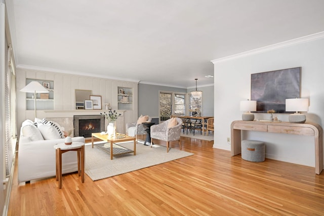 living room with hardwood / wood-style flooring and crown molding