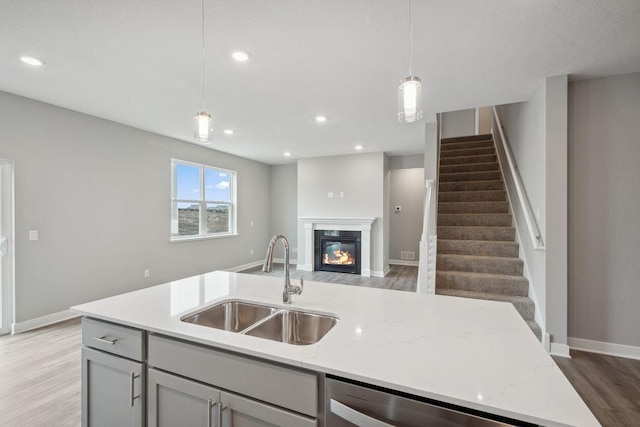 13617 Aulden Ave, Rosemount, MN 55068 - kitchen featuring open floor plan, a sink, hanging light fixtures, and light wood-style floors