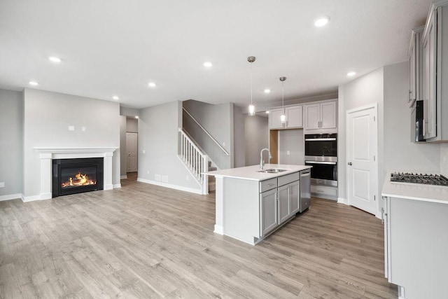 13617 Aulden Ave, Rosemount, MN 55068 - kitchen featuring recessed lighting, gray cabinets, a sink, light wood-type flooring, and appliances with stainless steel finishes