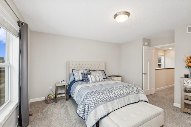 carpeted bedroom with a textured ceiling