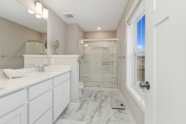 bathroom featuring vanity, an enclosed shower, and toilet