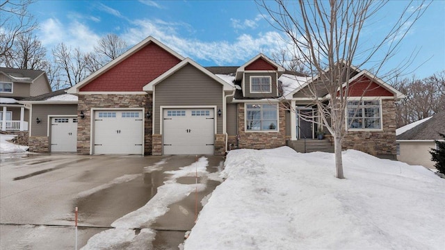 craftsman house featuring an attached garage, stone siding, and driveway