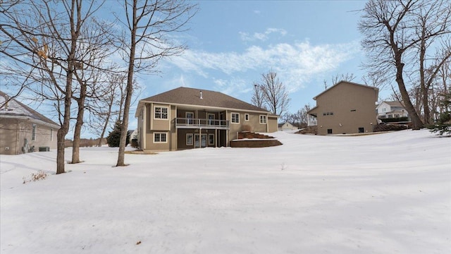 snow covered property featuring a balcony