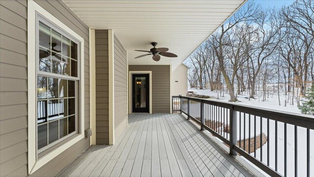 snow covered deck with a ceiling fan