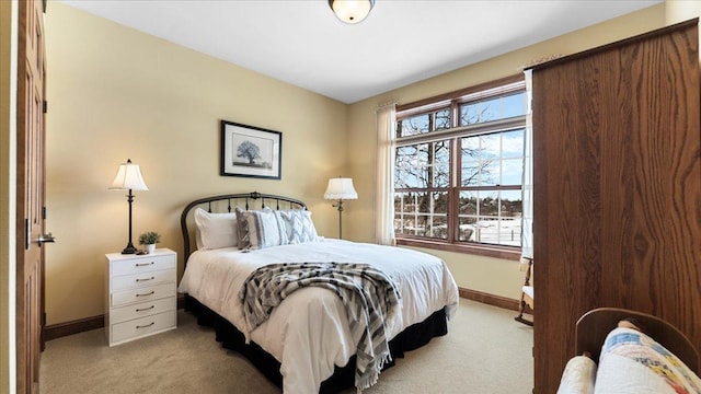 bedroom with light carpet and baseboards