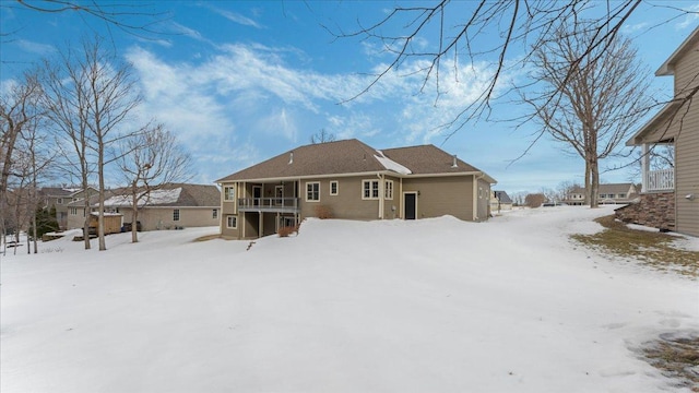 view of snow covered rear of property