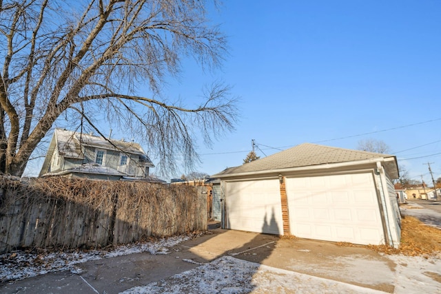 view of home's exterior with a garage and an outbuilding