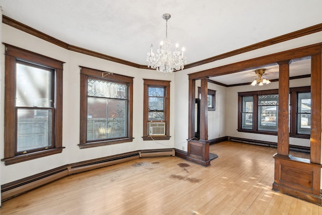 unfurnished dining area featuring ornate columns, crown molding, light wood-type flooring, baseboard heating, and a wealth of natural light