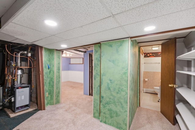 basement with carpet and a paneled ceiling