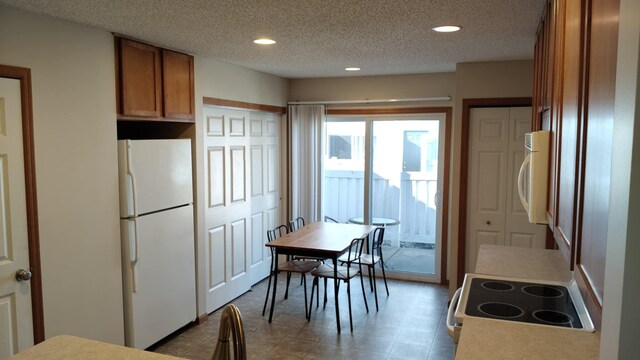 4970 149th St N Unit 3, Hugo, MN 55038 - kitchen with white appliances, brown cabinets, recessed lighting, and a textured ceiling