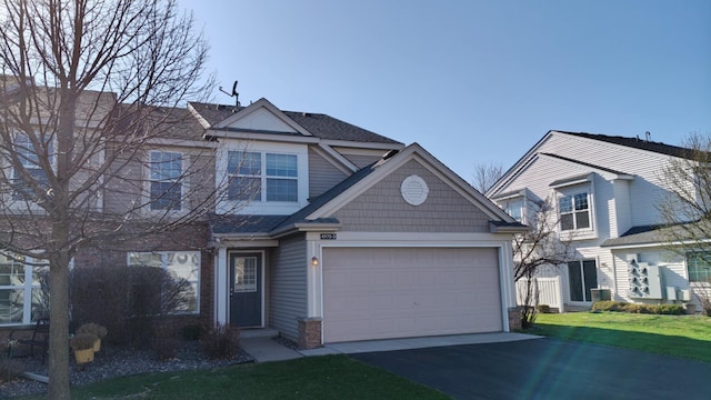 4970 149th St N Unit 3, Hugo, MN 55038 - view of front of house featuring asphalt driveway, a front yard, and an attached garage