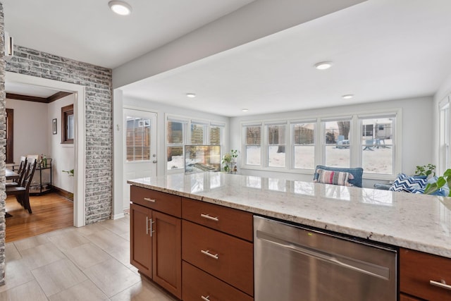 kitchen with light stone countertops and dishwasher