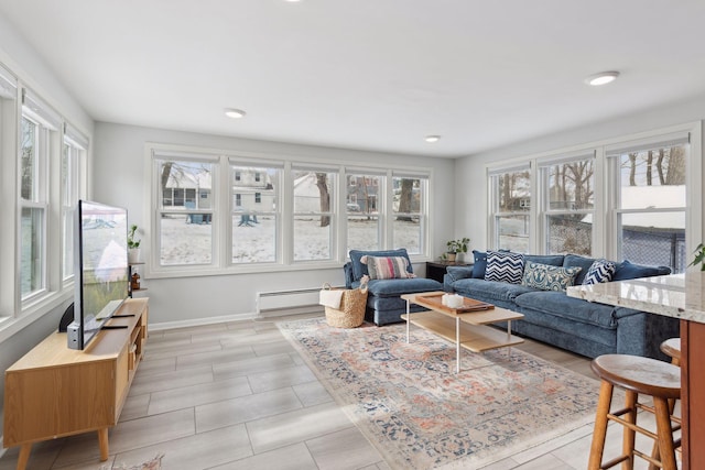 living room with a baseboard radiator and a healthy amount of sunlight