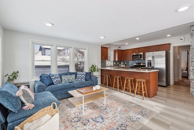 living room featuring sink and light wood-type flooring