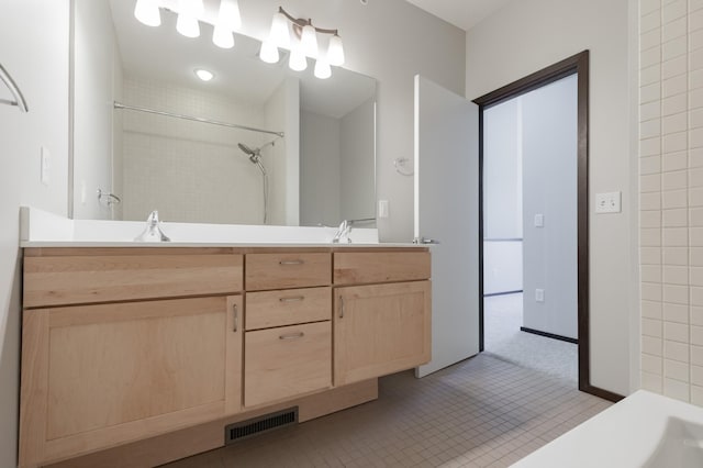 bathroom featuring vanity, tile patterned flooring, and walk in shower