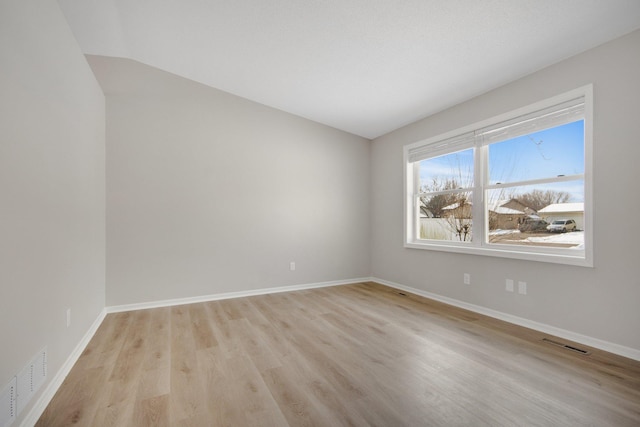 unfurnished room with light hardwood / wood-style floors