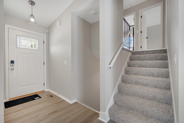 foyer entrance with light hardwood / wood-style floors