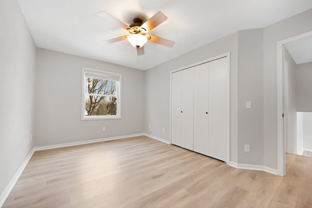 unfurnished bedroom with ceiling fan, light hardwood / wood-style floors, and a closet