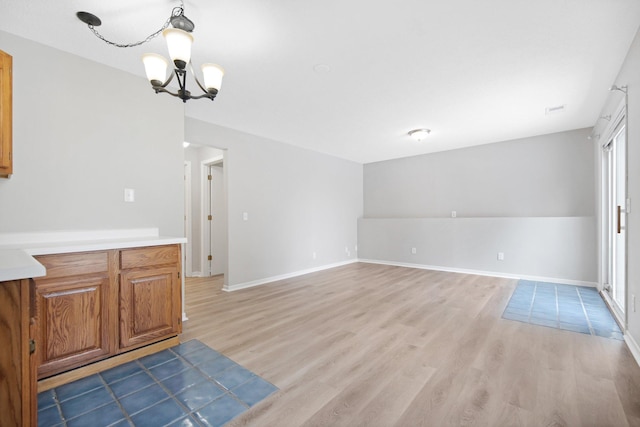 interior space with a notable chandelier and light wood-type flooring