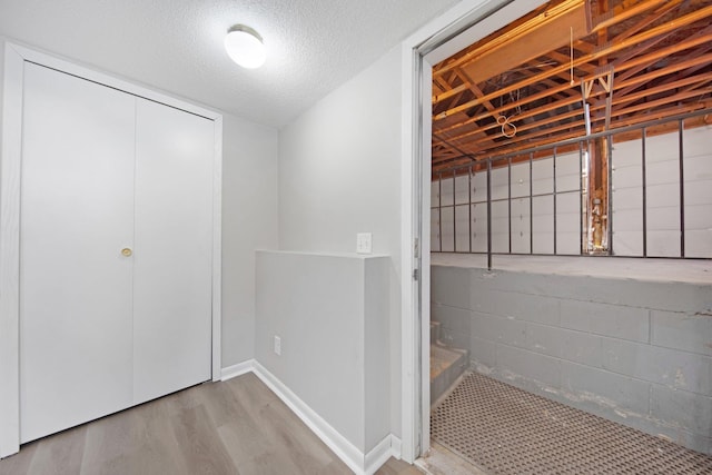 interior space with a textured ceiling and light wood-type flooring