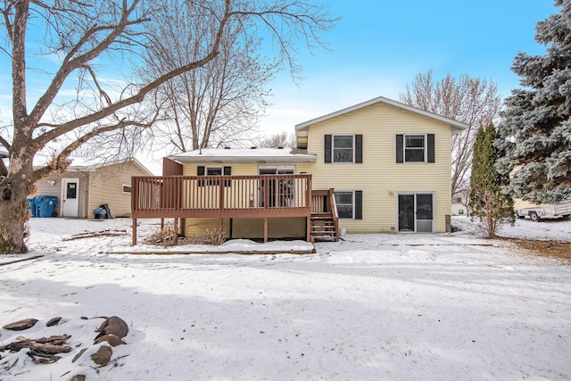 snow covered property with a wooden deck