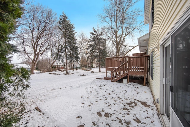 yard layered in snow featuring a wooden deck